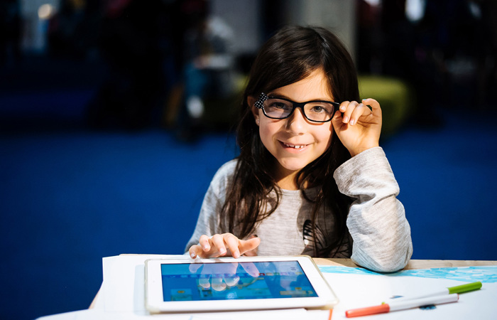 Happy girl engaging in a STEM activity.